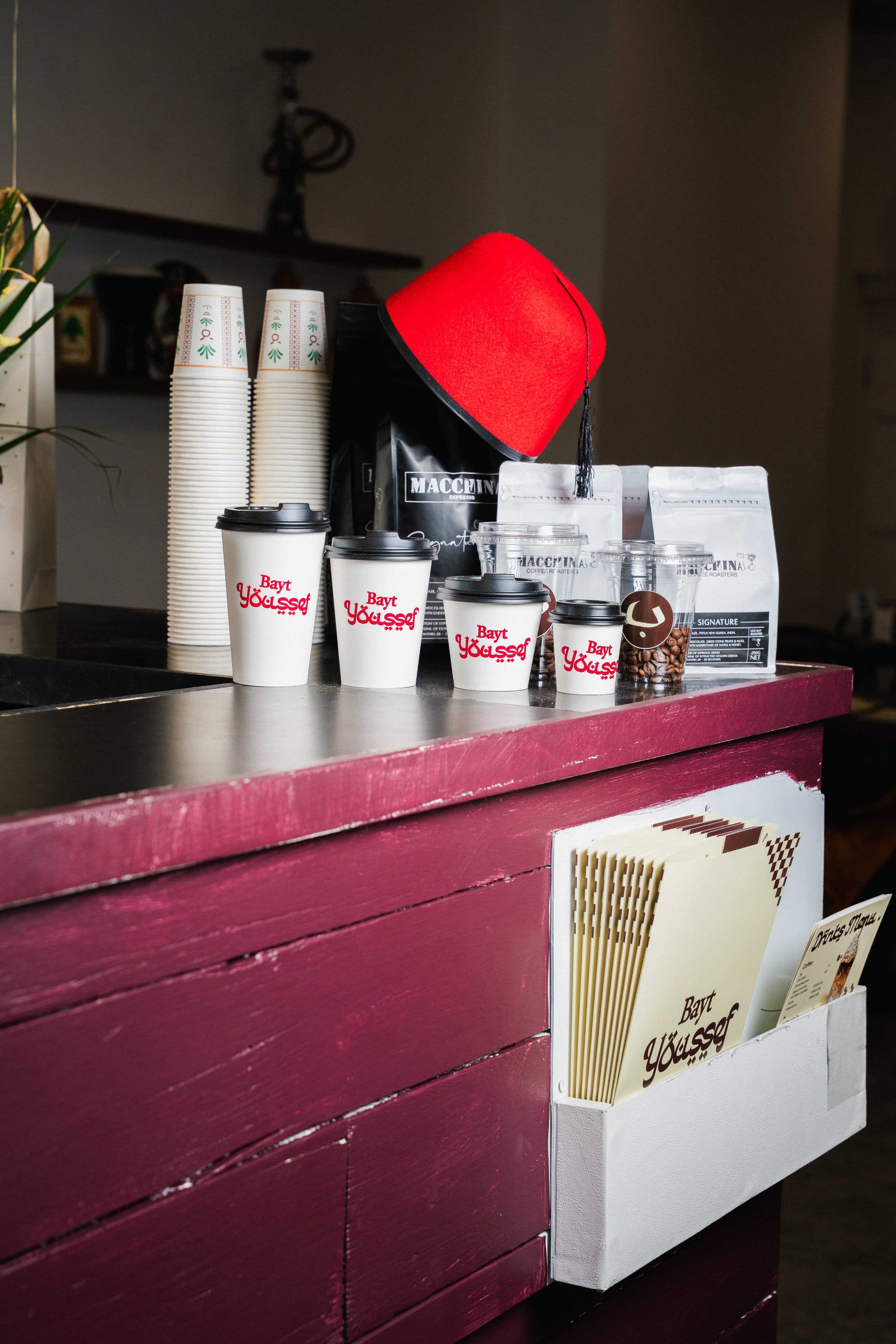 Bayt Youssef menu and branded coffee cup display