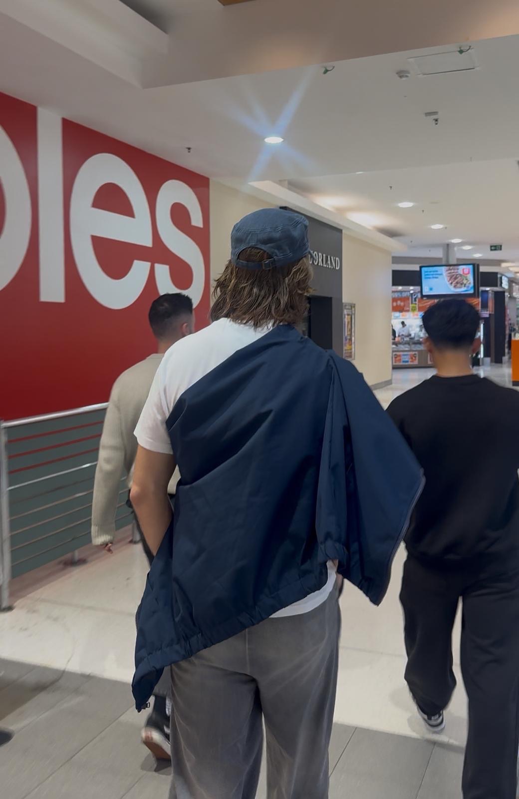 Production team scouting and filming inside a Perth retail location