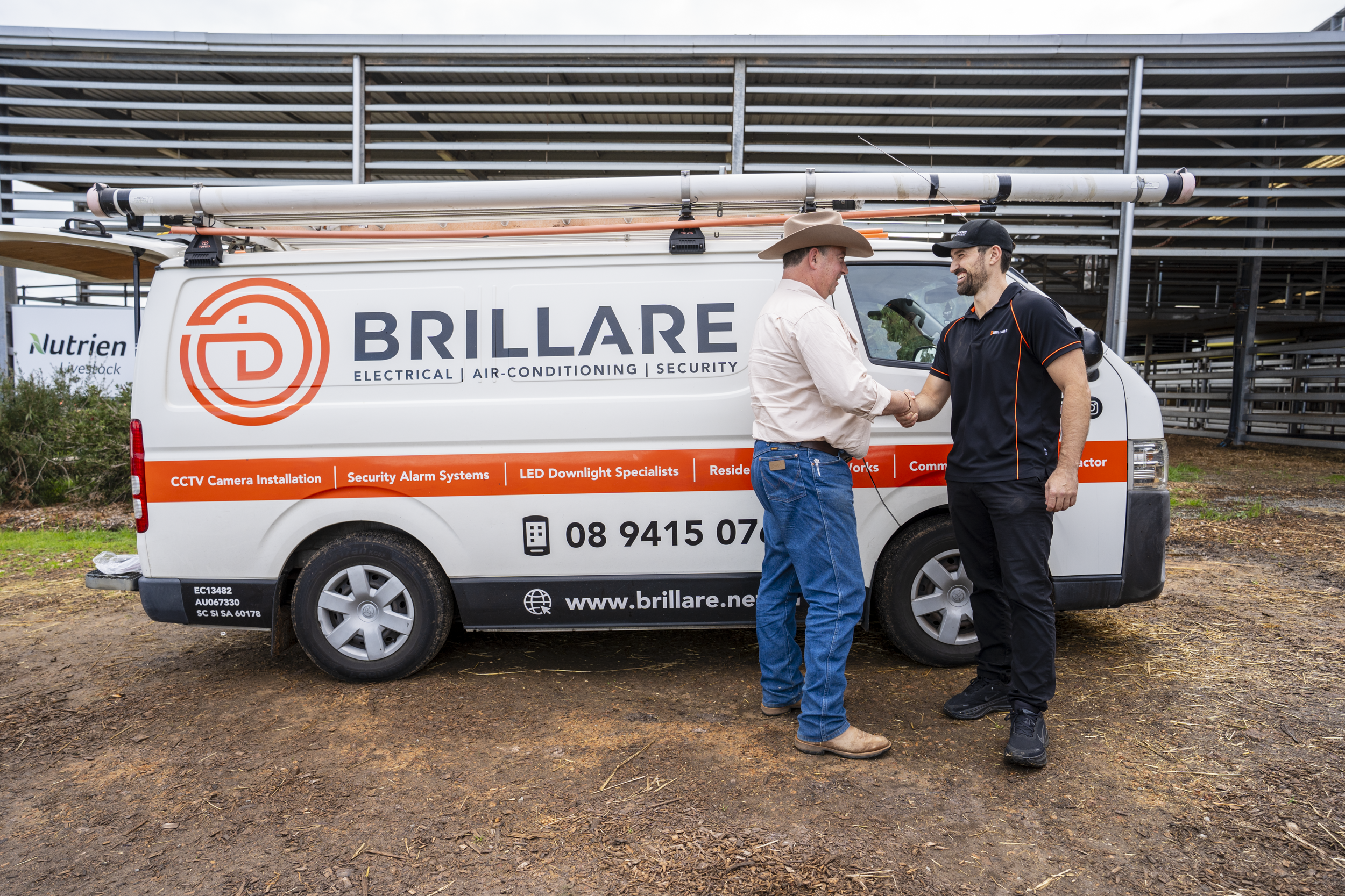 Brillare electrician meeting a client beside a branded service vehicle