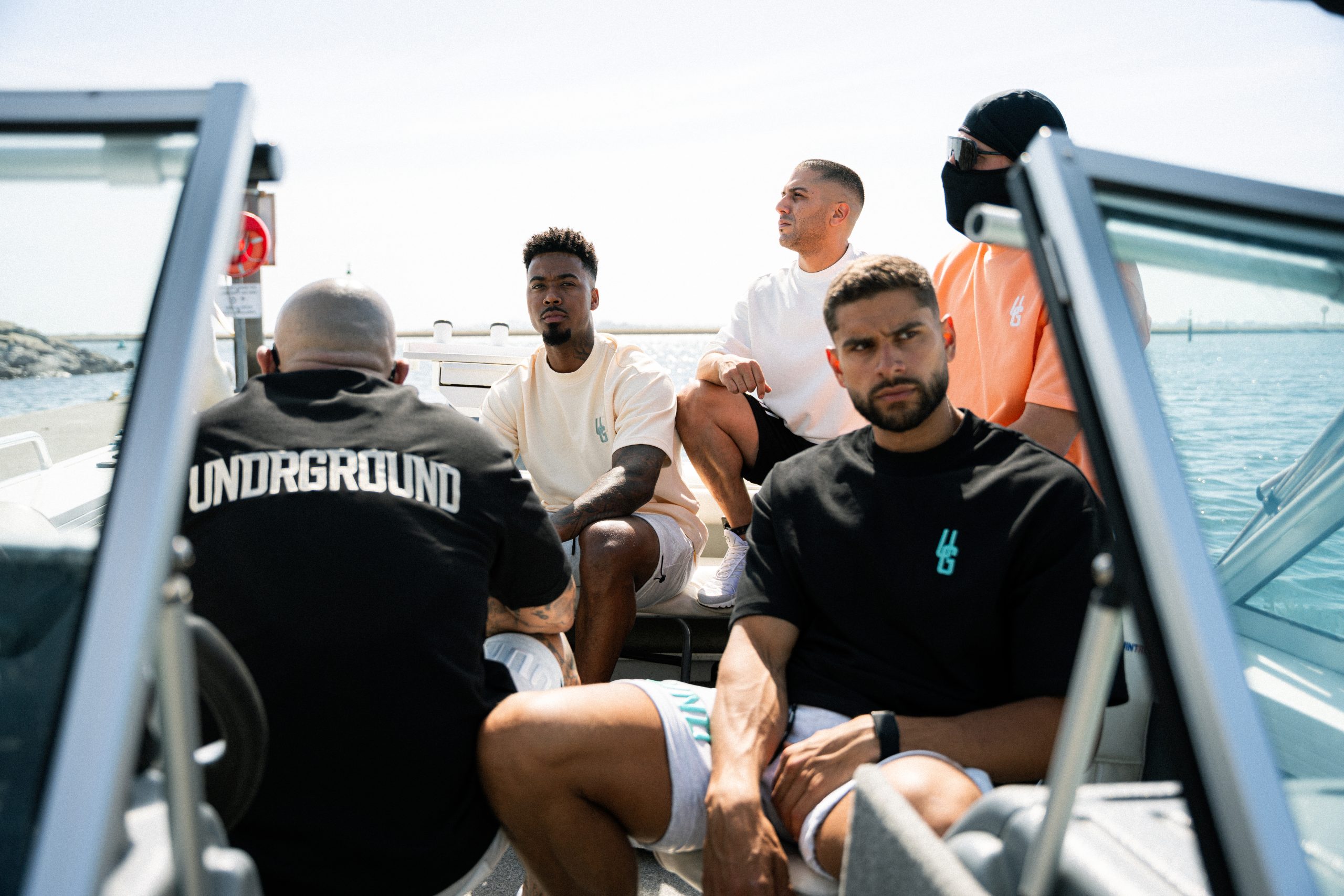 UNDRGROUND models wearing the collection aboard a boat