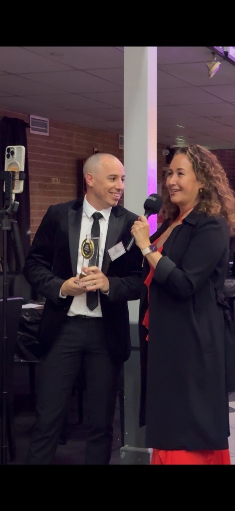 Pedro being interviewed while holding his Latin Awards Australia 2026 trophy
