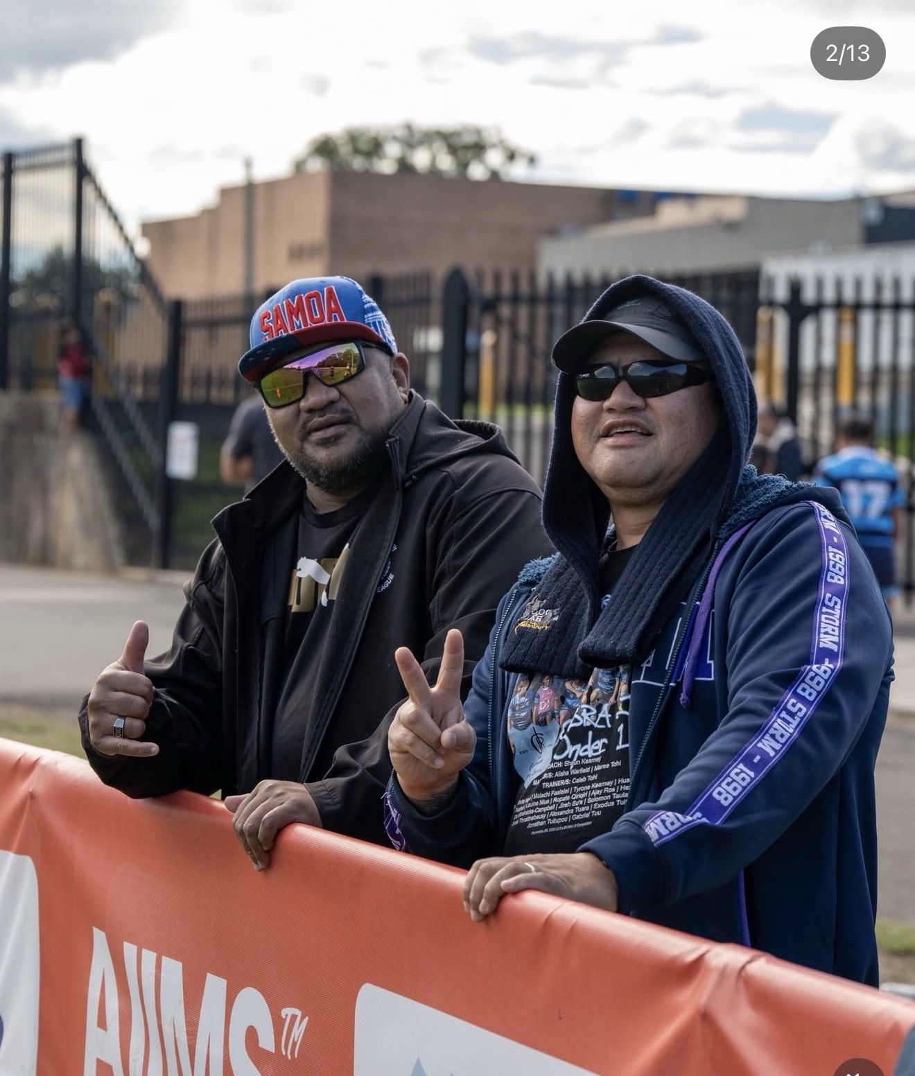 Supporters beside AIIMS branded signage at Cabramatta Two Blues