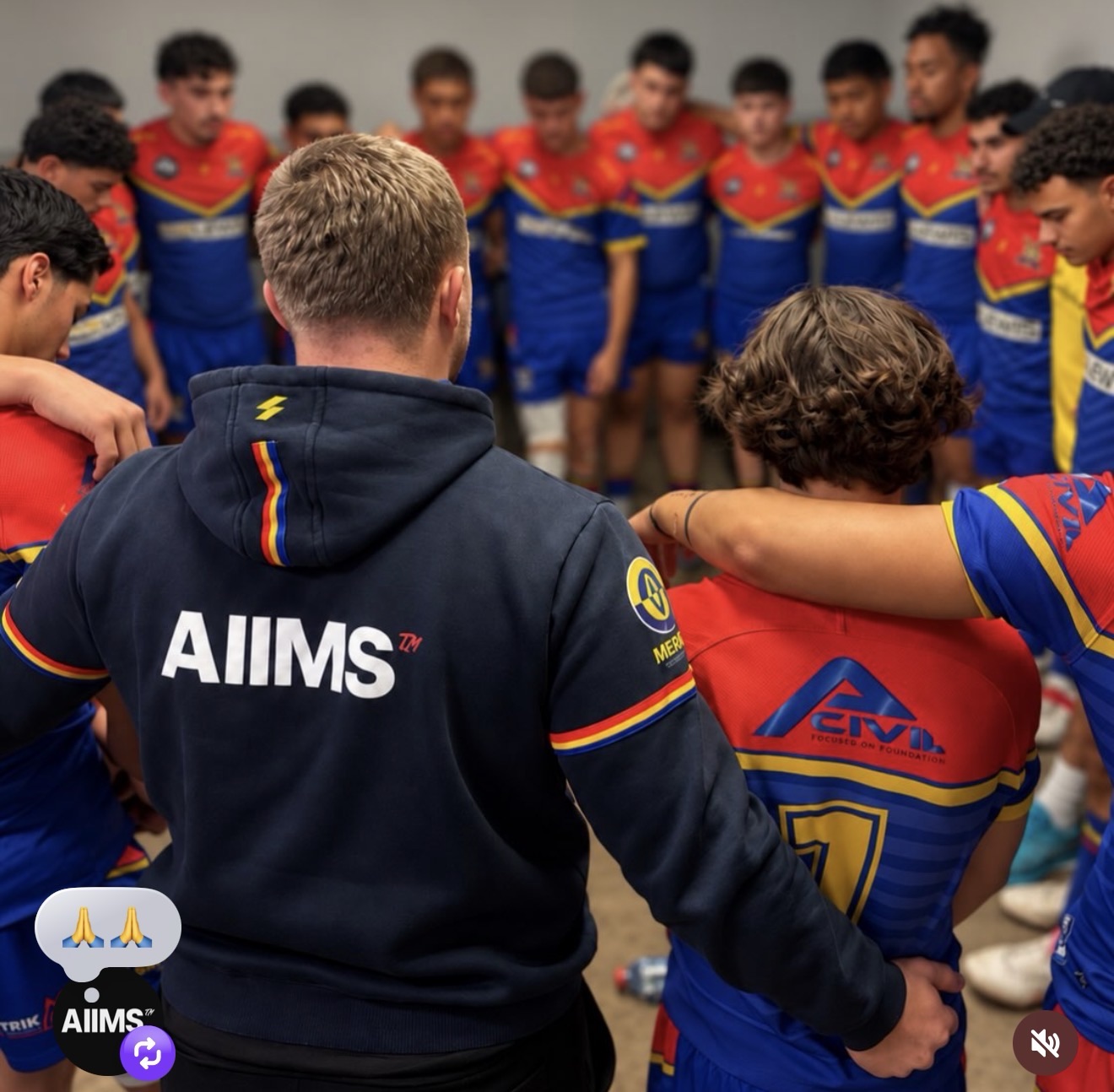 St John’s Eagles team huddle with AIIMS branding on a team hoodie